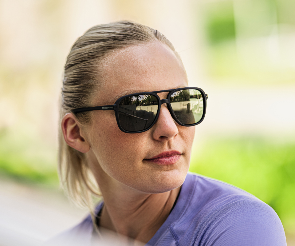 Woman wearing purple shirt and Bandera sunglasses