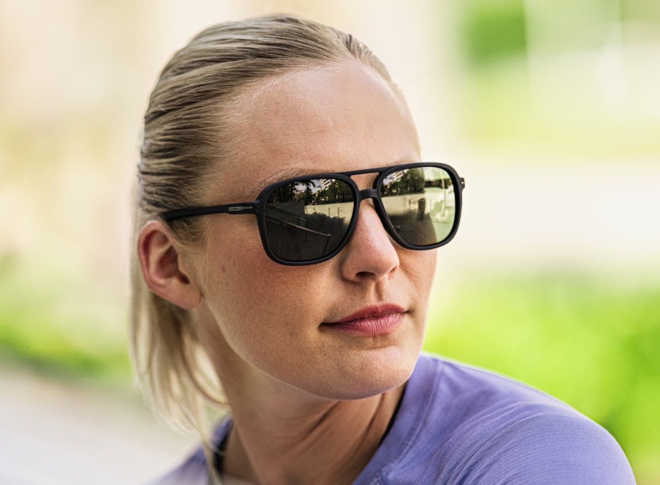 Woman wearing purple shirt and Bandera sunglasses