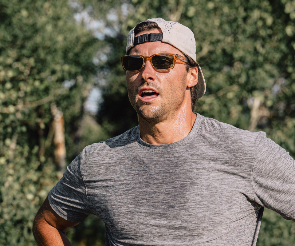 Man sweating wearing backwards hat and Mayfield sunglasses