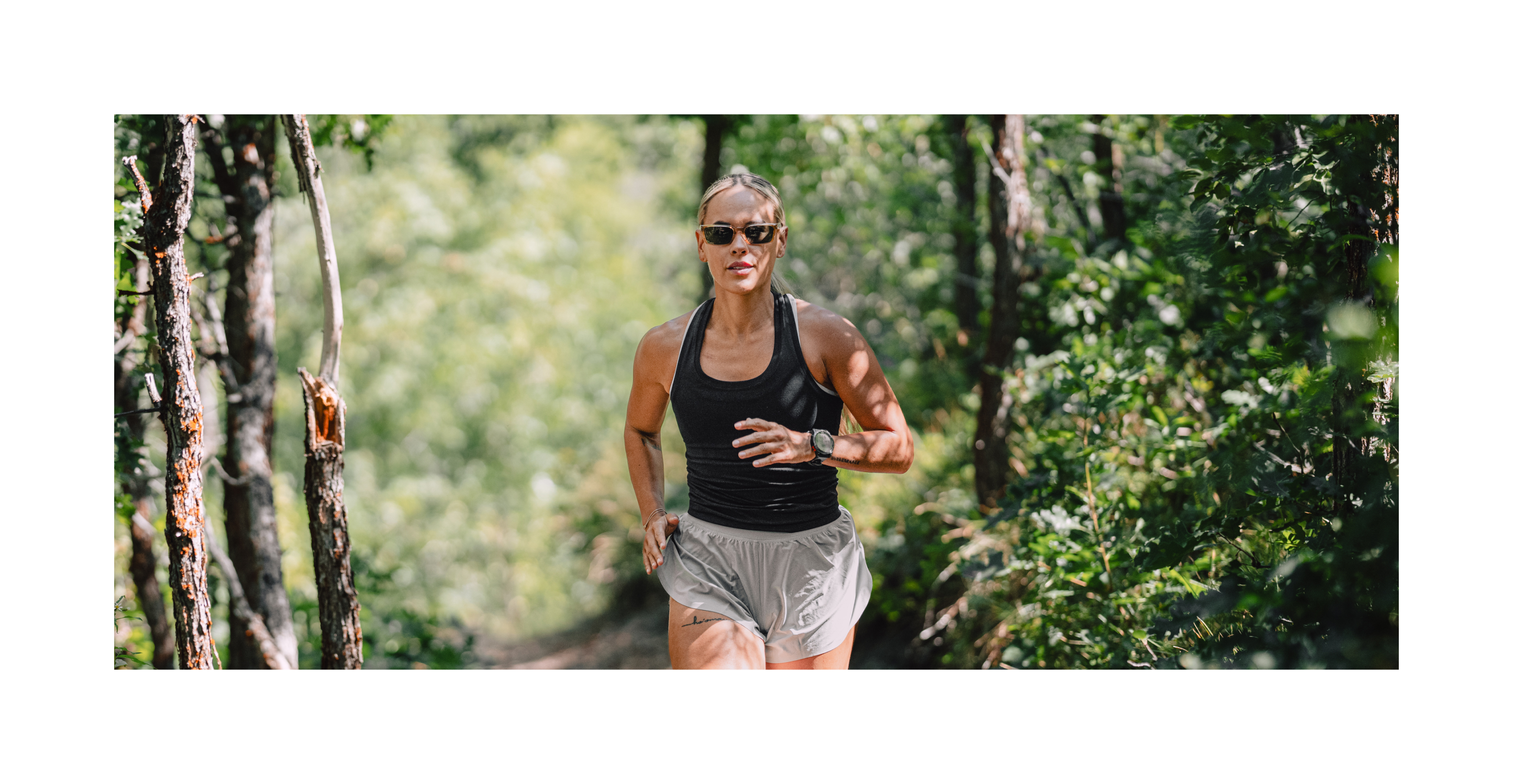 Woman running in Mayfield sunglasses in the woods