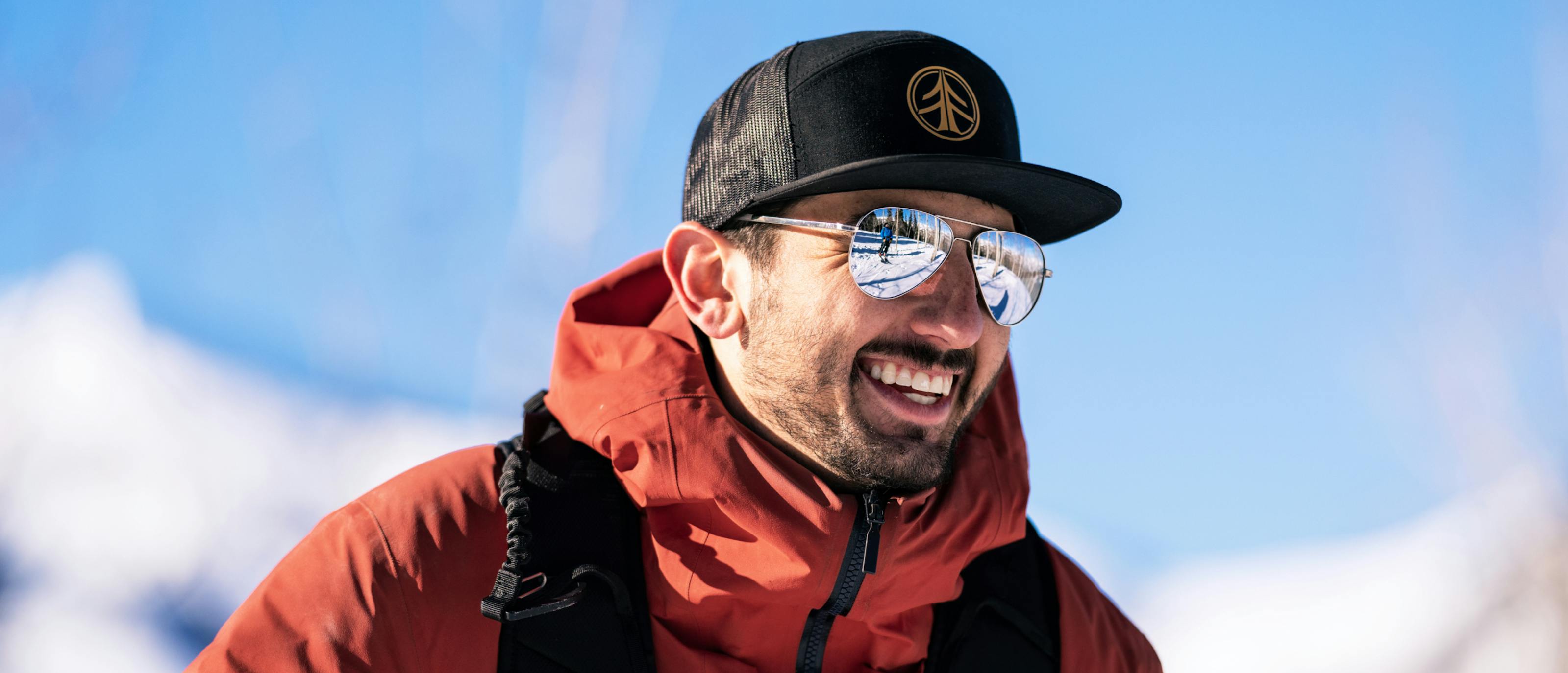 Man wearing black hat and Phantom mirrored sunglasses