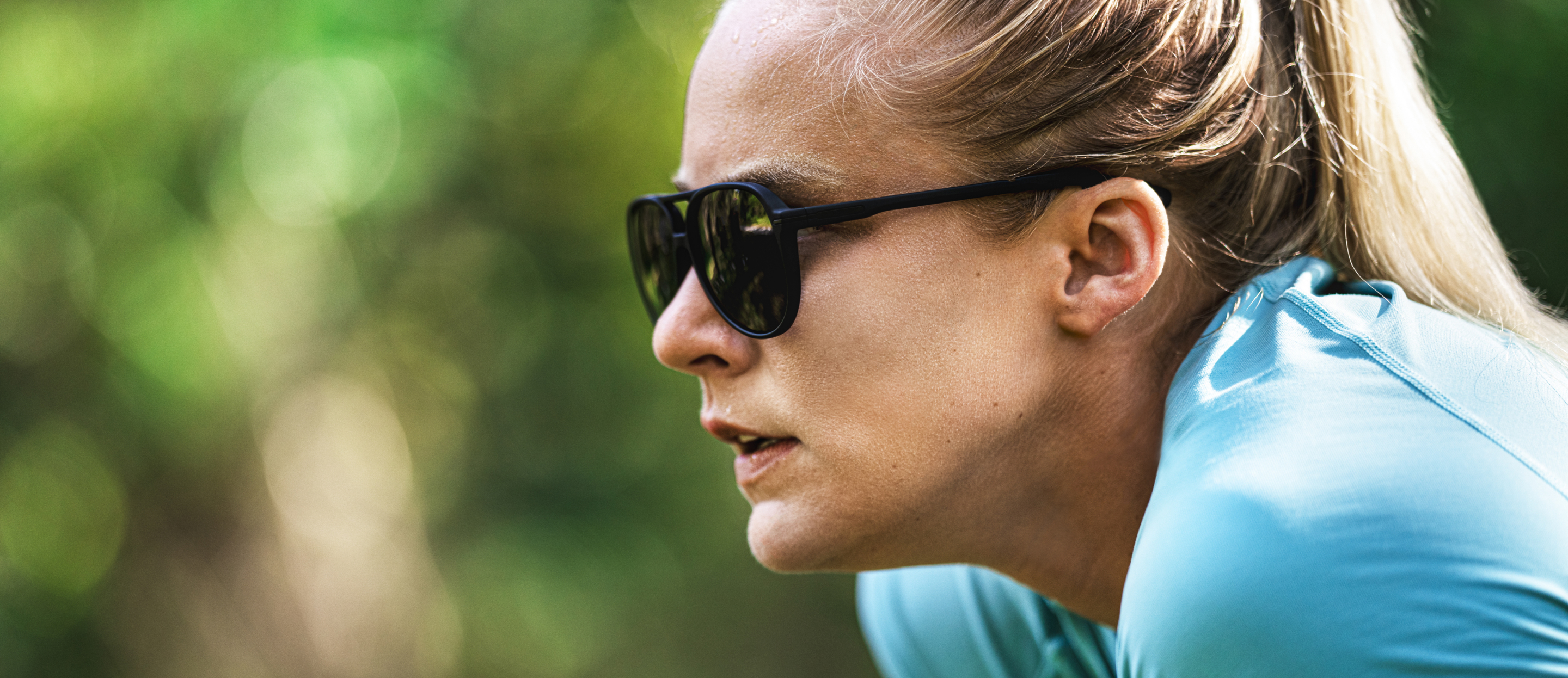 Woman wearing blue top and Havana sunglasses
