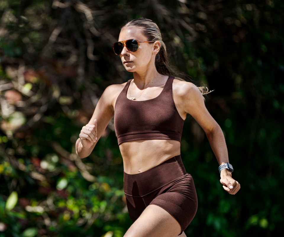 Woman running in woods in Havana sunglasses