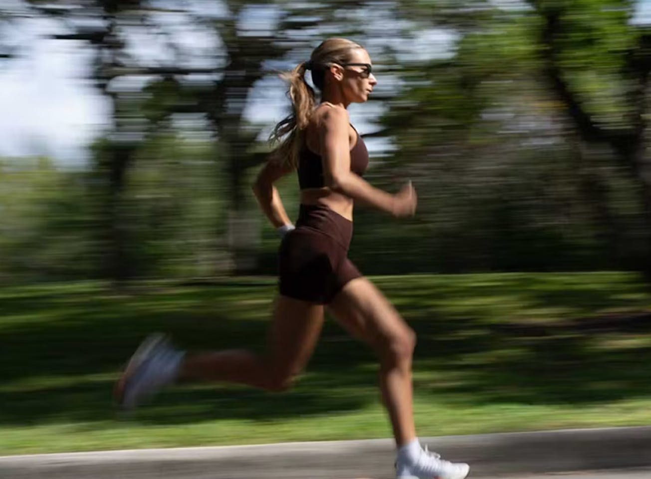 Woman running in woods in Havana sunglasses