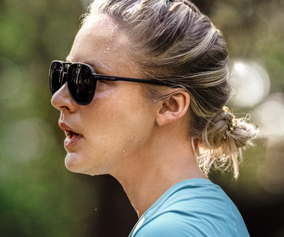 Woman wearing blue top and Havana sunglasses