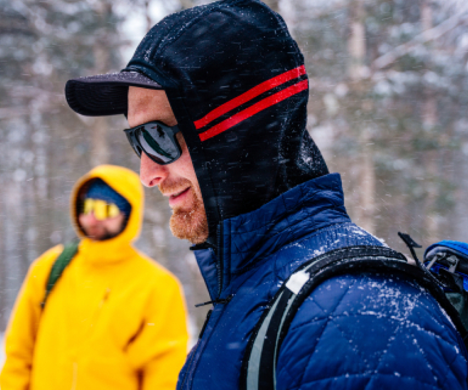 Man in snow wearing hoodie and Torino sunglasses