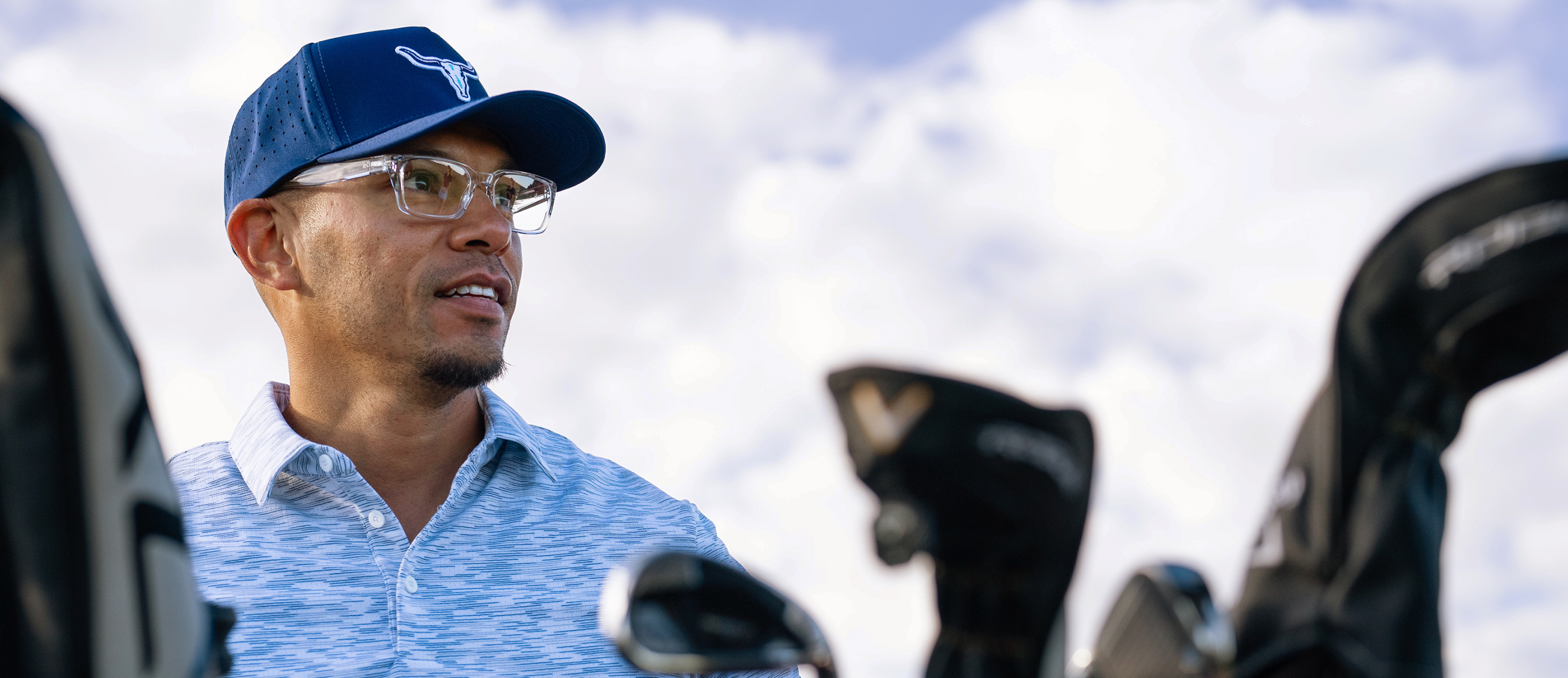 Men with golf clubs wearing Mayfield eyeglasses