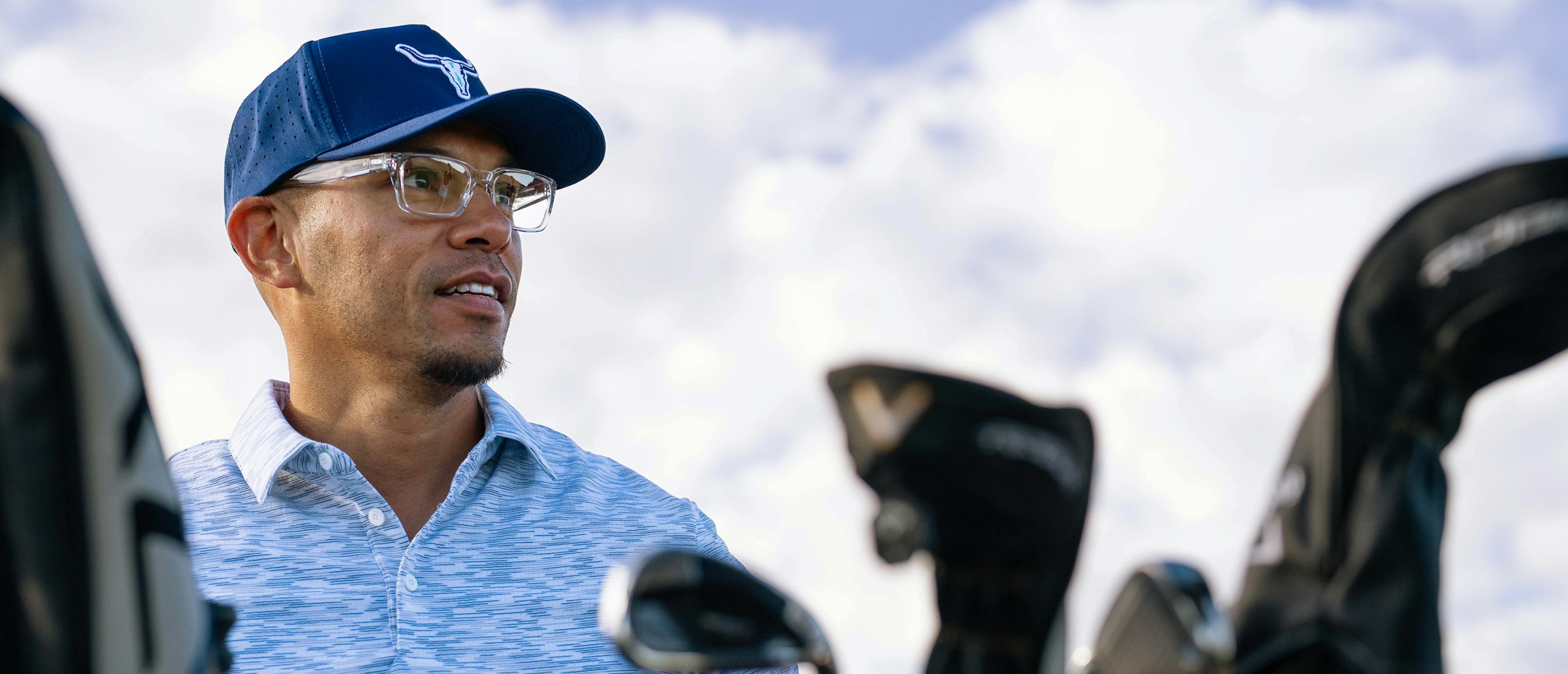Men with golf clubs wearing Mayfield eyeglasses