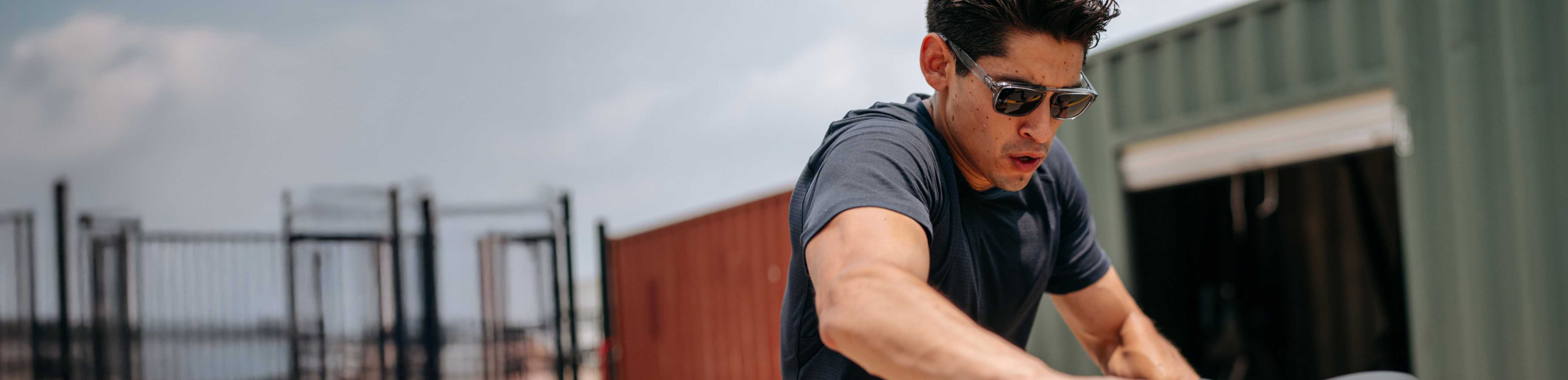 Man riding stationary bike wearing Estacado sunglasses