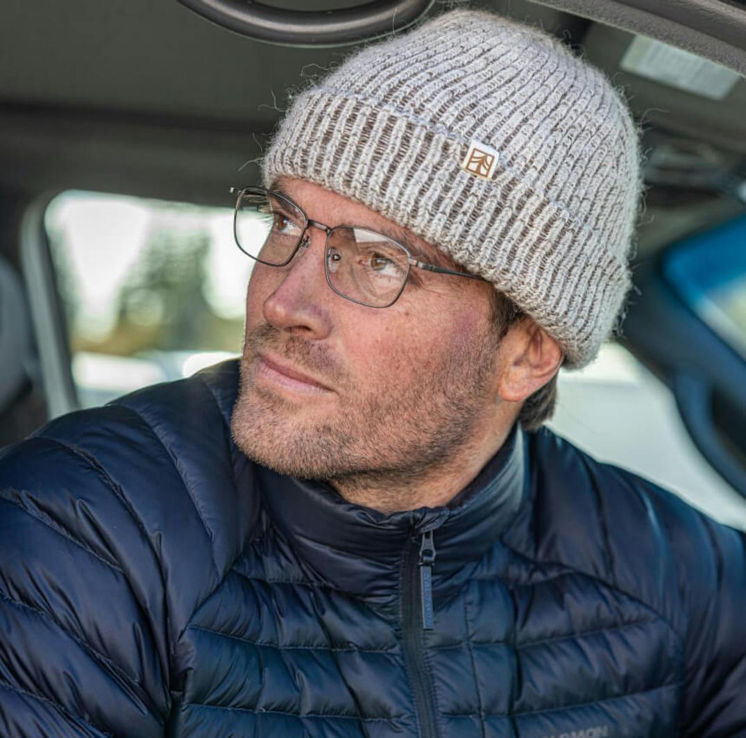 Man wearing wire frame glasses and gray beanie hat