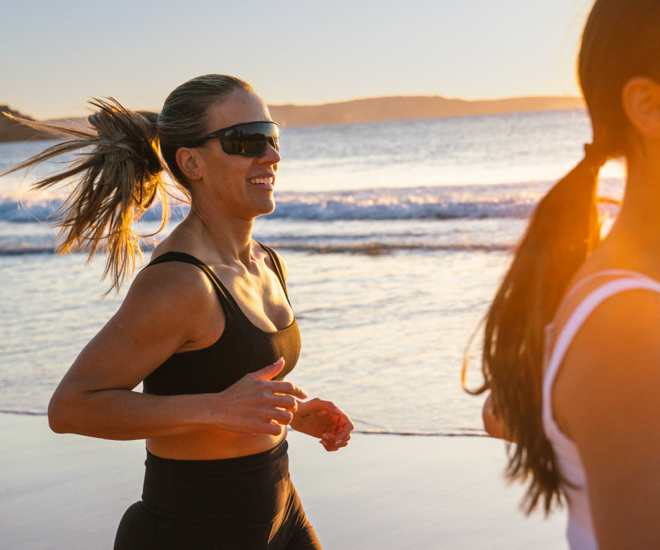 Woman jogging on beach wearing  CP-1x sunglasses