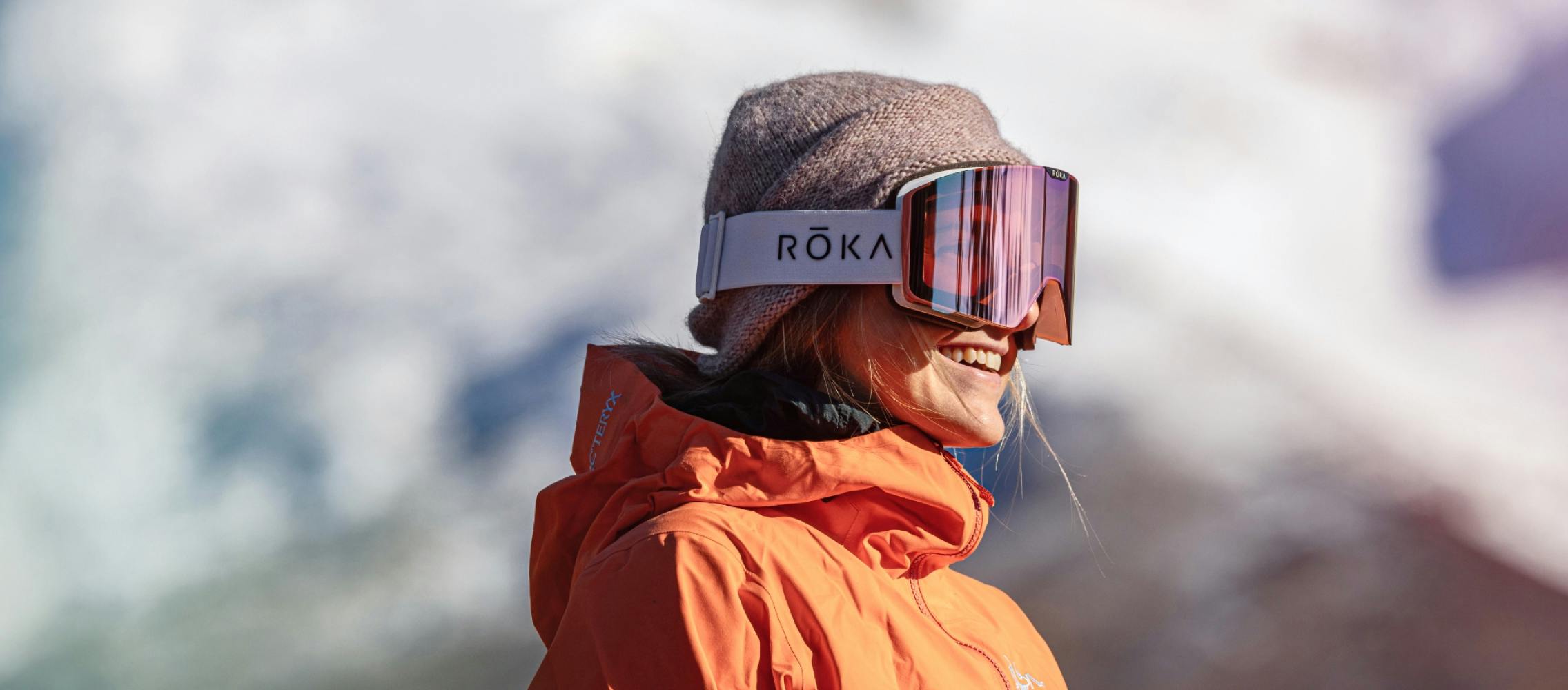 Woman smiling wearing ROKA snow goggles