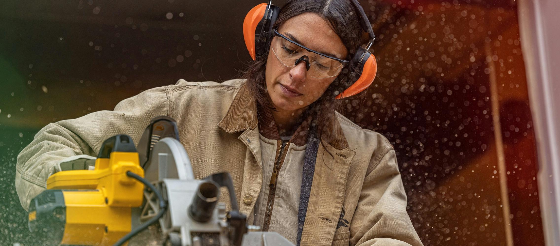 Woman using saw wearing ROKA protective glasses