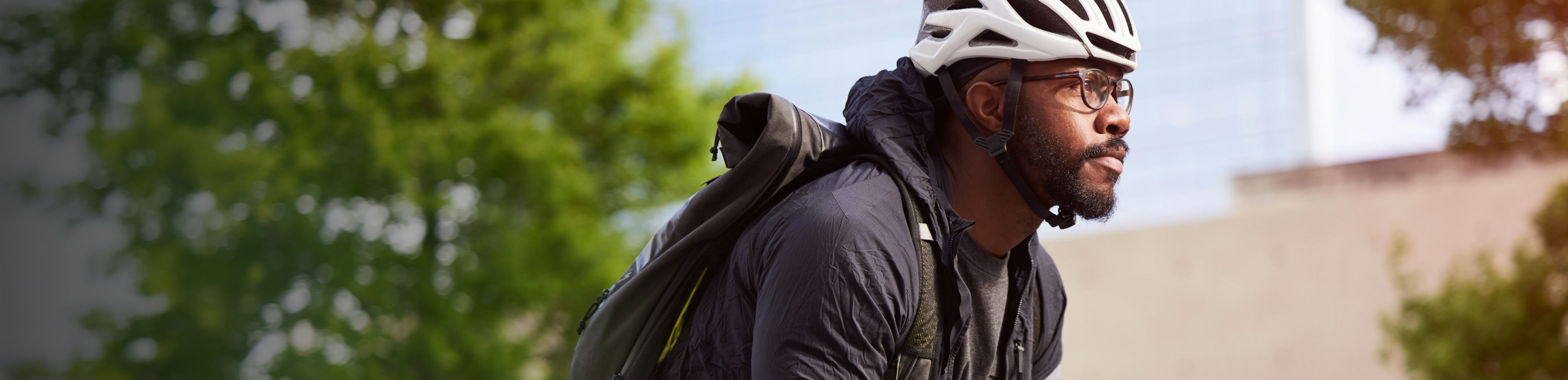 Man on bike wearing helmet and glasses