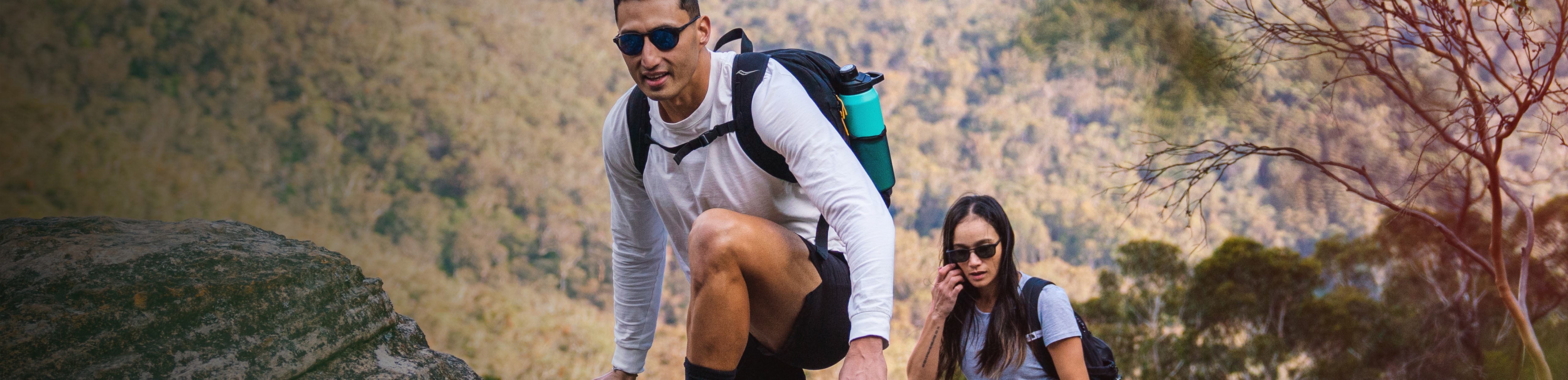 Man and woman hiking wearing ROKA sunglasses