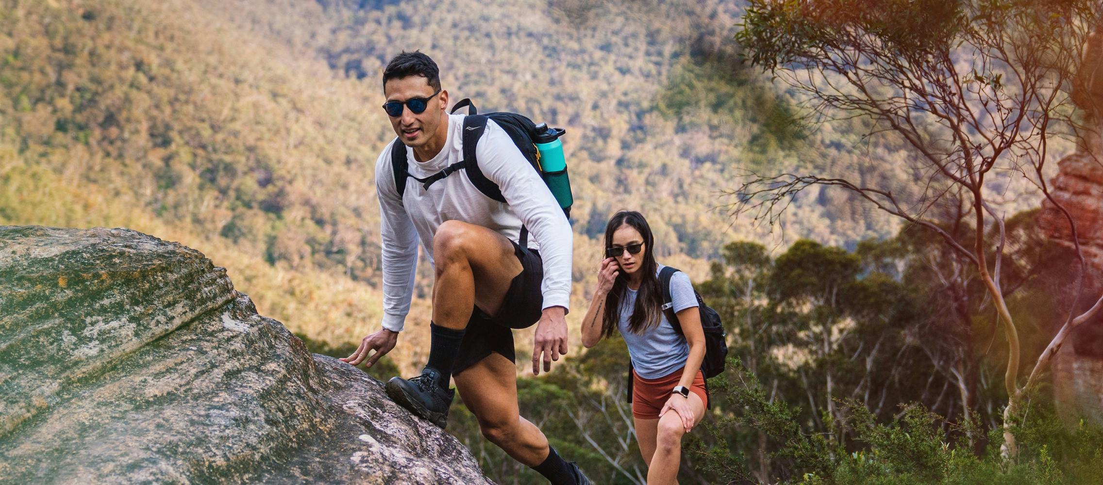 Man and woman hiking wearing ROKA sunglasses