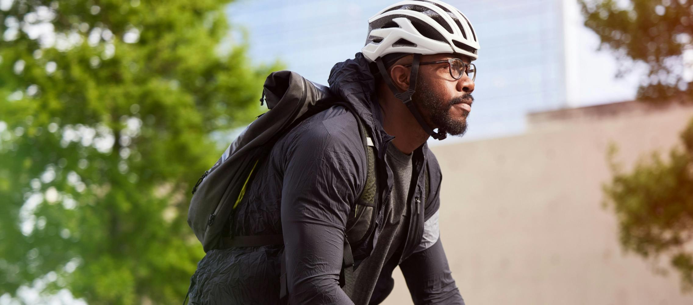 Man on bike wearing helmet and glasses