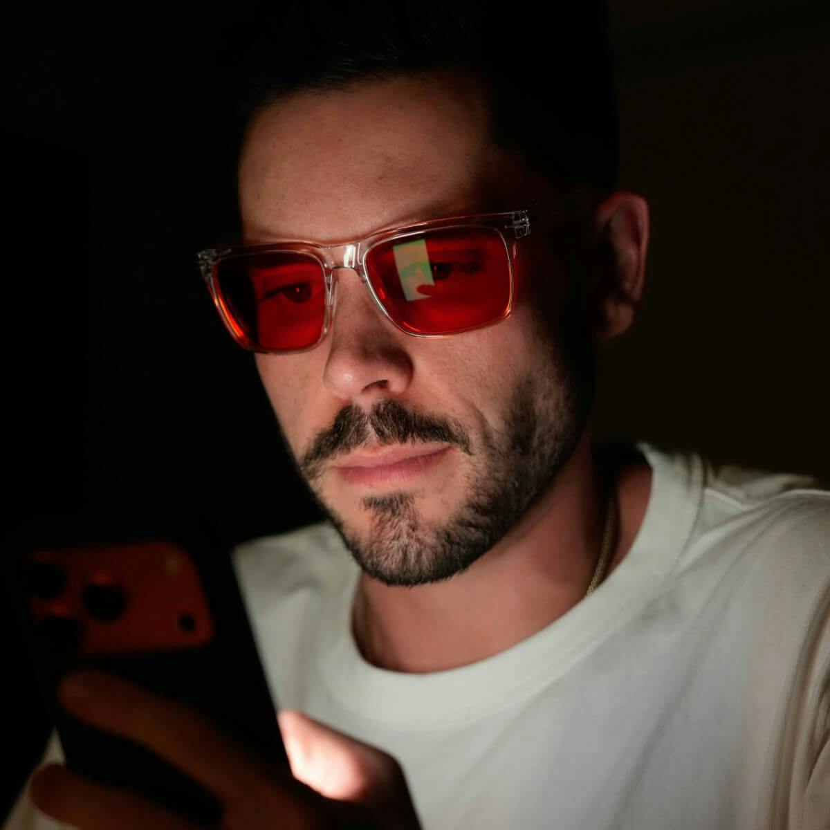 Man looking at screen wearing Wind Down glasses.