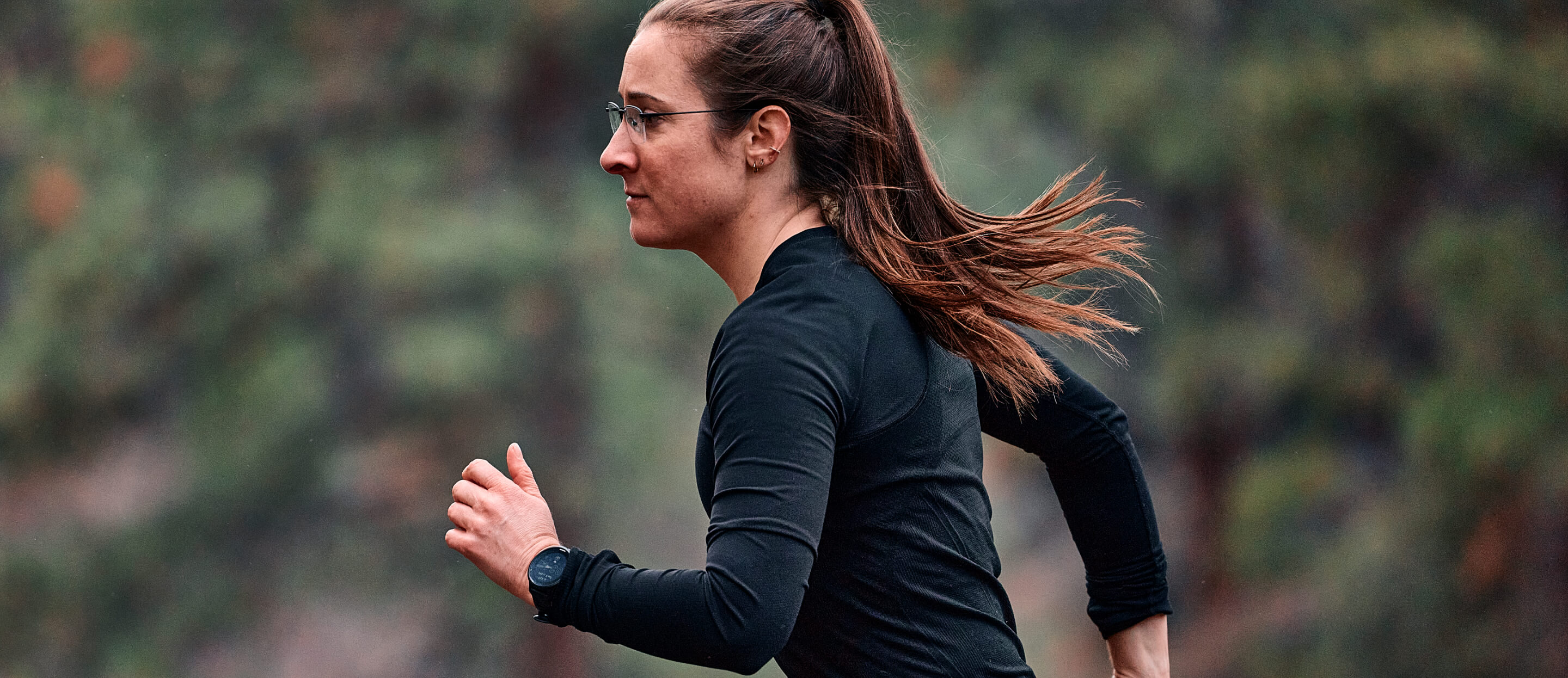 Woman running in woods wearing Vapor Nano glasses