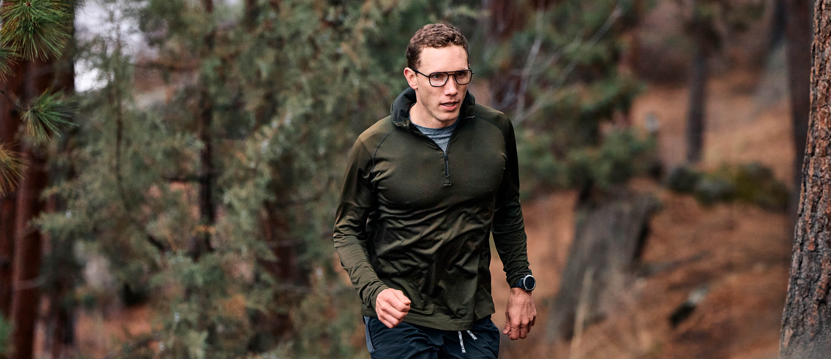 Man running in woods wearing Falcon Fusion eyeglasses
