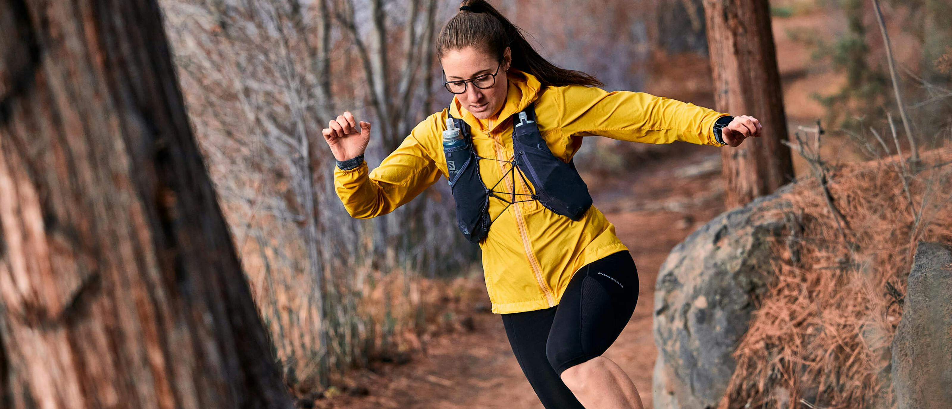 Woman running in woods wearing Falcon Fusion eyeglasses