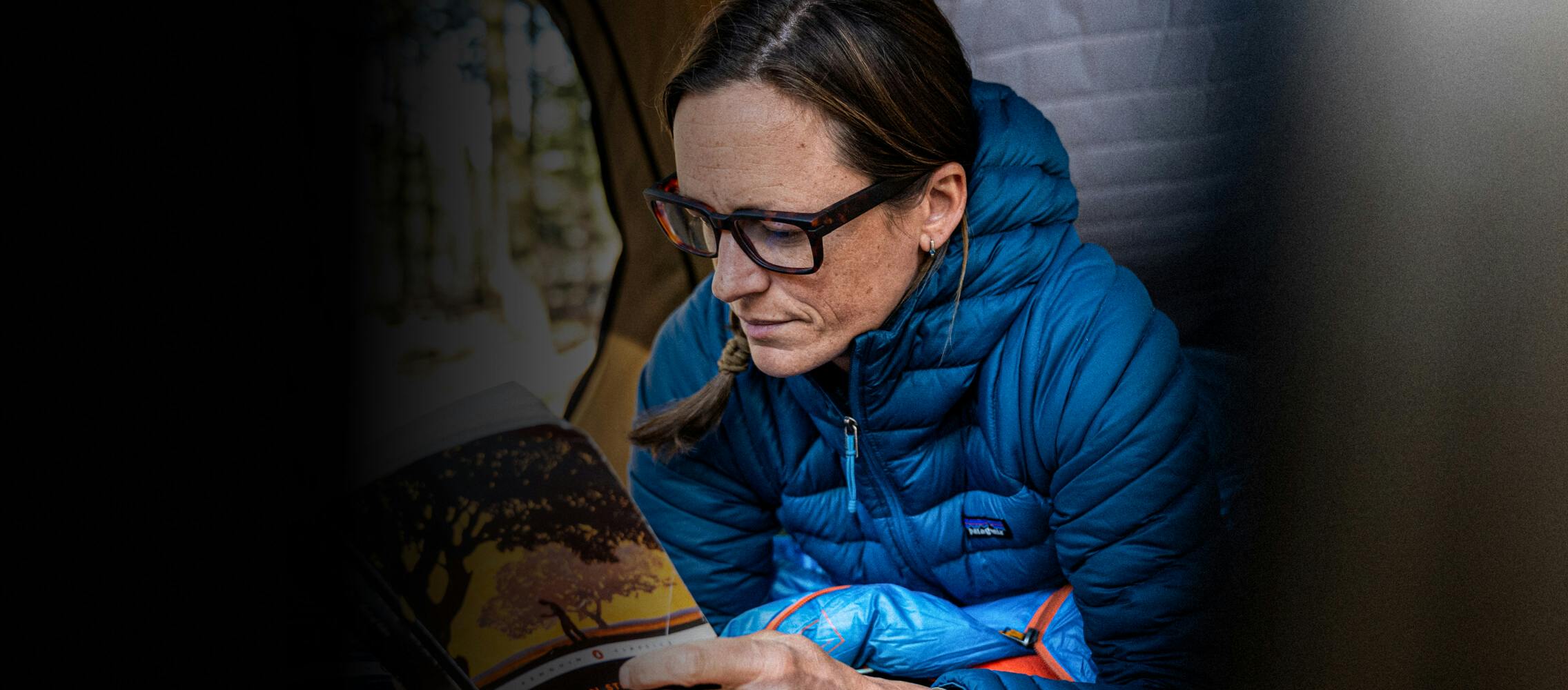 Woman in ROKA Readers and puffy hiking jacket