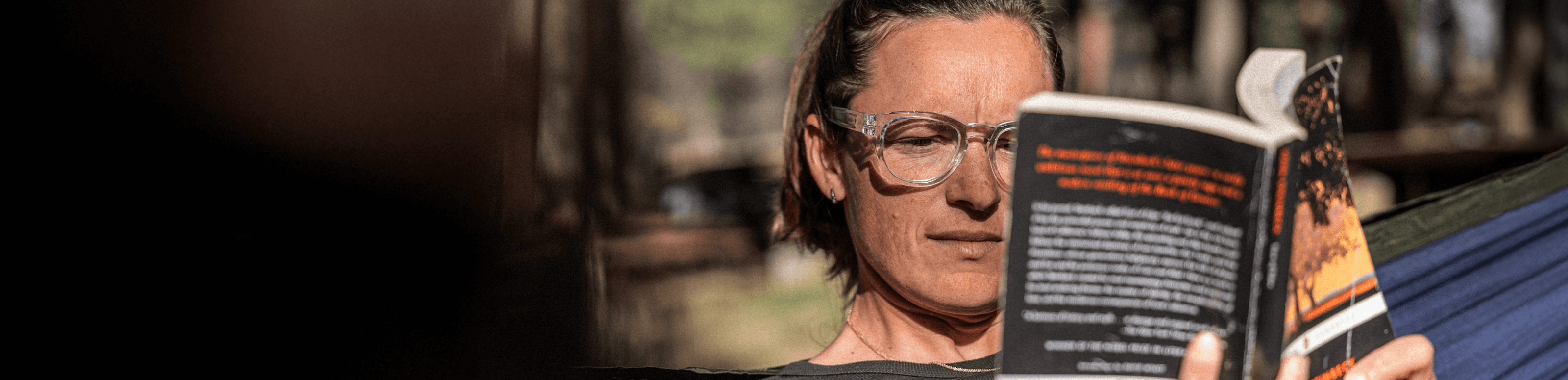 Woman reading while wearing ROKA eyeglasses