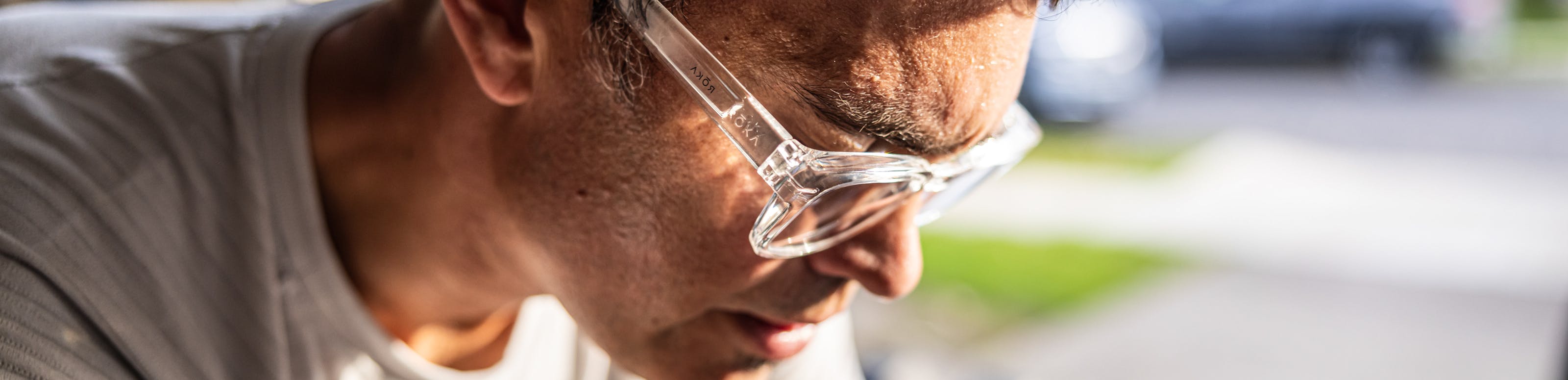 Man riding stationary bike with reading glasses on.