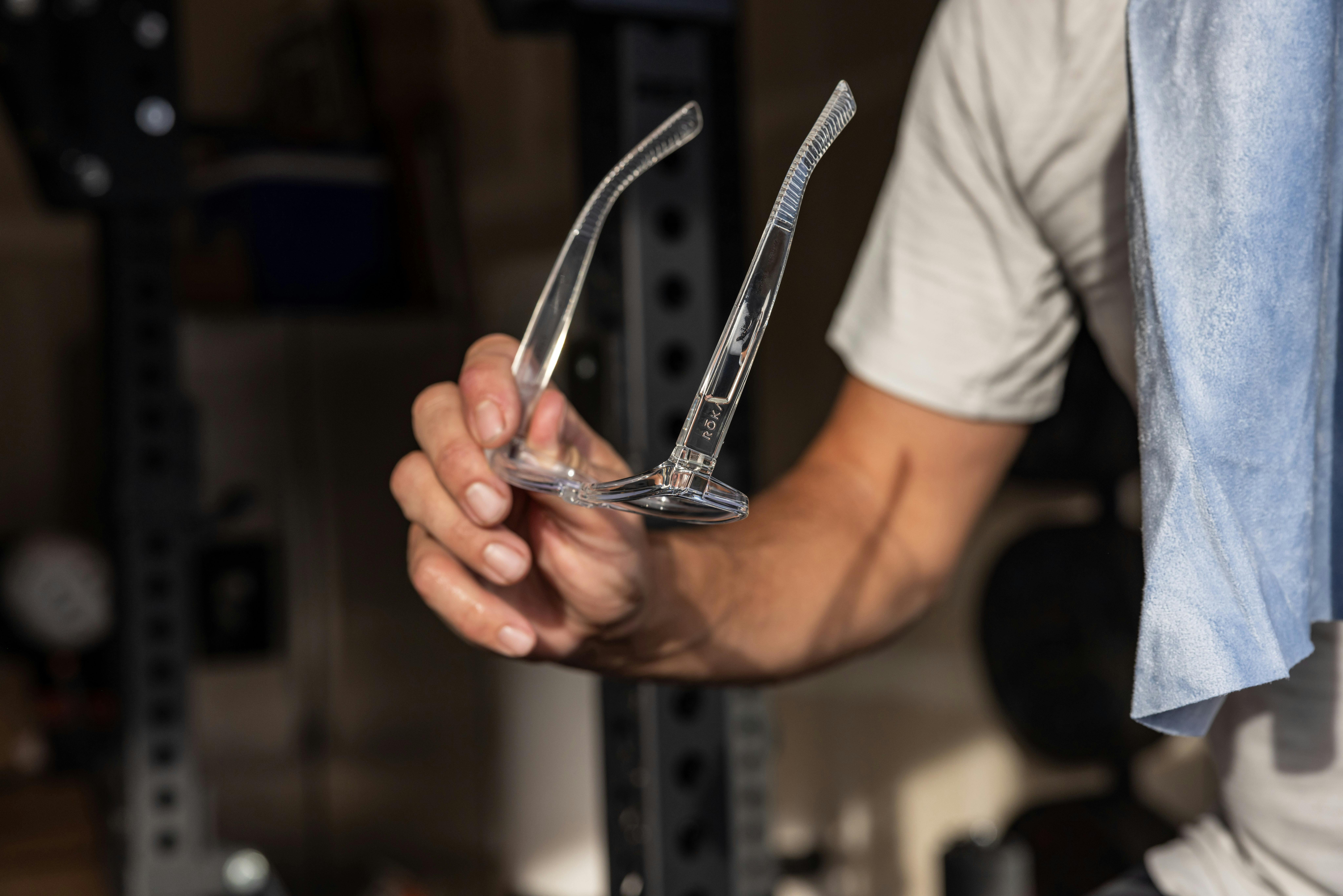 Reading glasses being held in hand