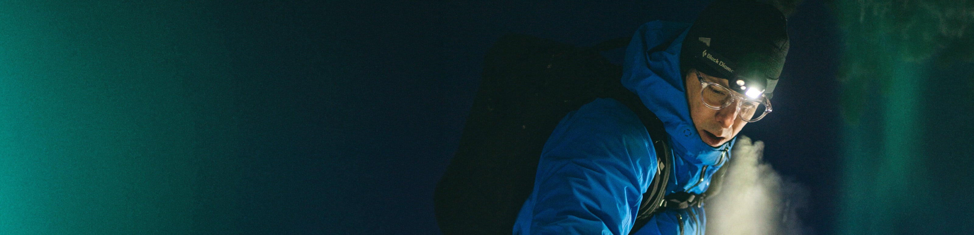 Man in blue snow jacket and ROKA eyeglasses