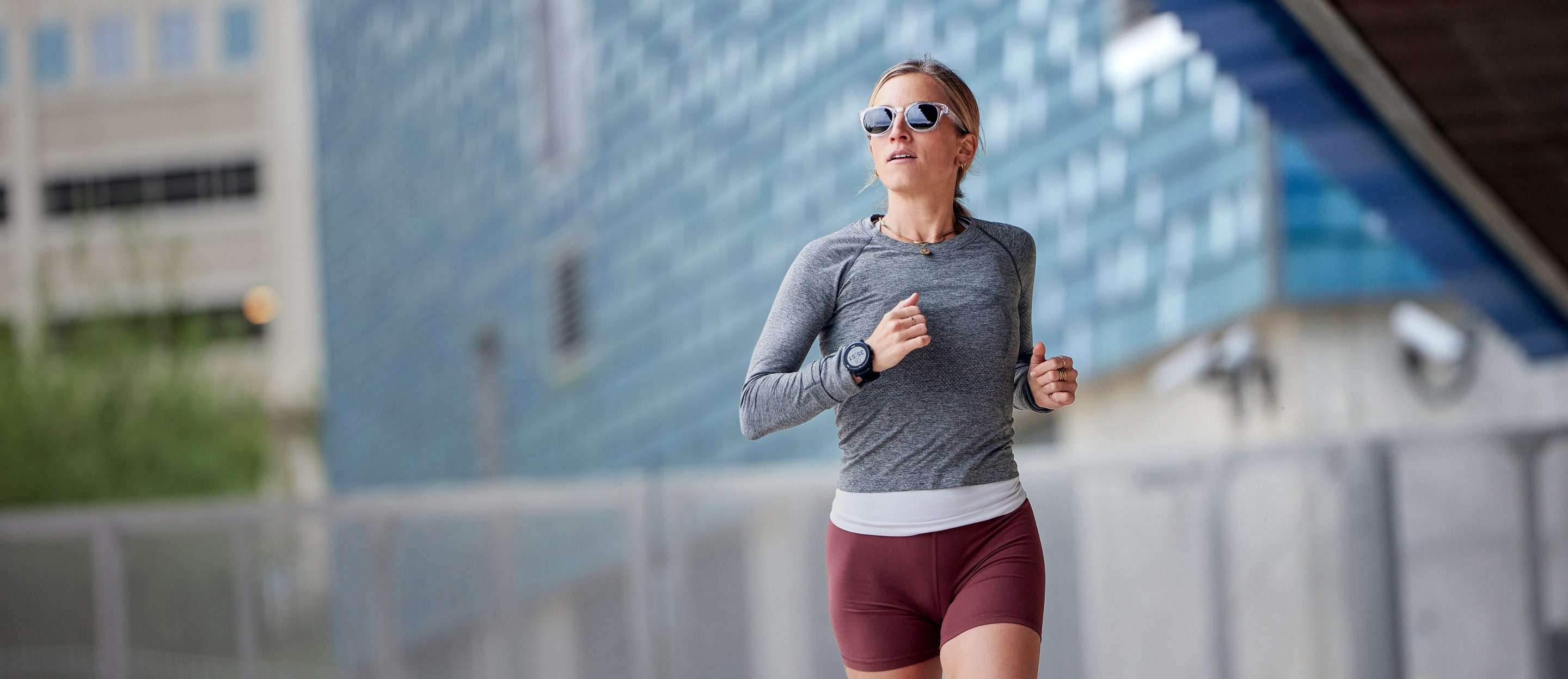 Woman running in city wearing Hamilton sunglasses