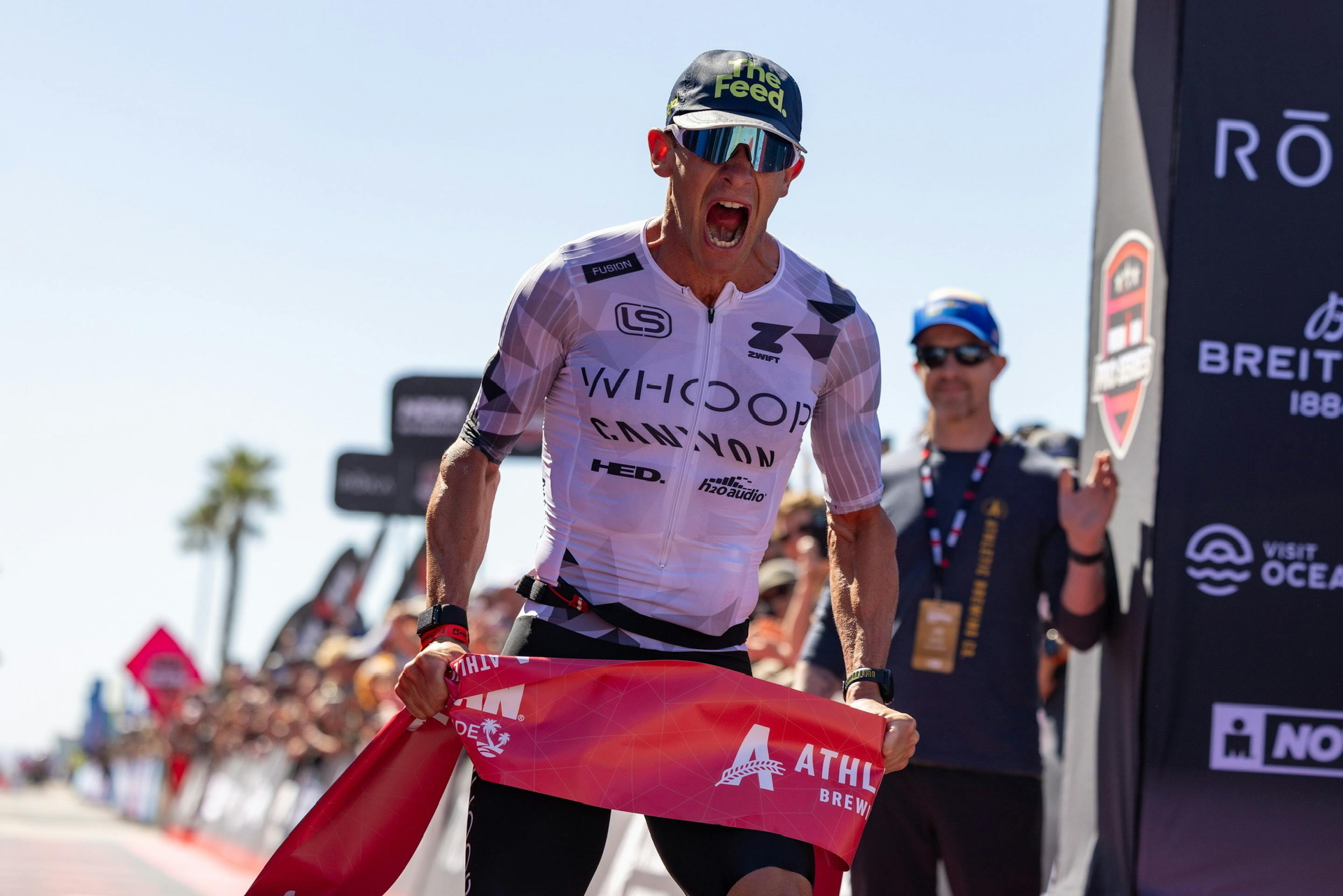 lionel sanders crossing the finish line at an ironman event