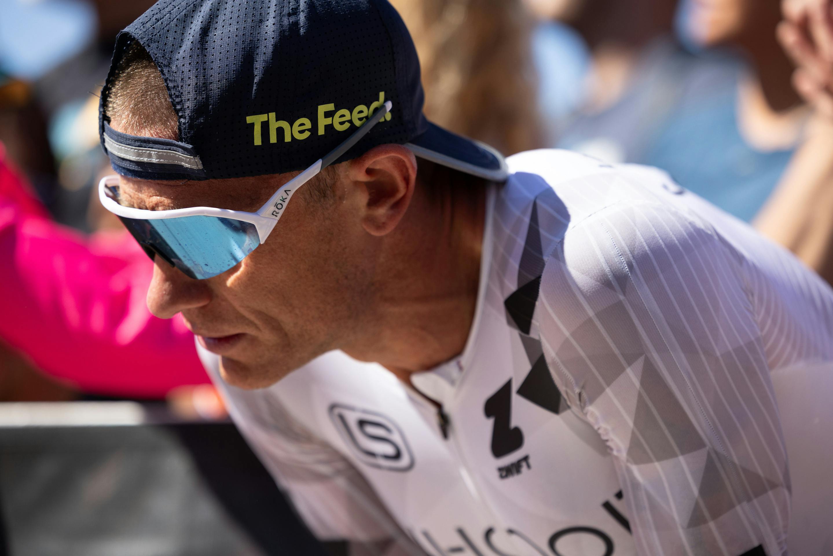 man training with blue mirrored shield sunglasses on, close up image focused on eyewear
