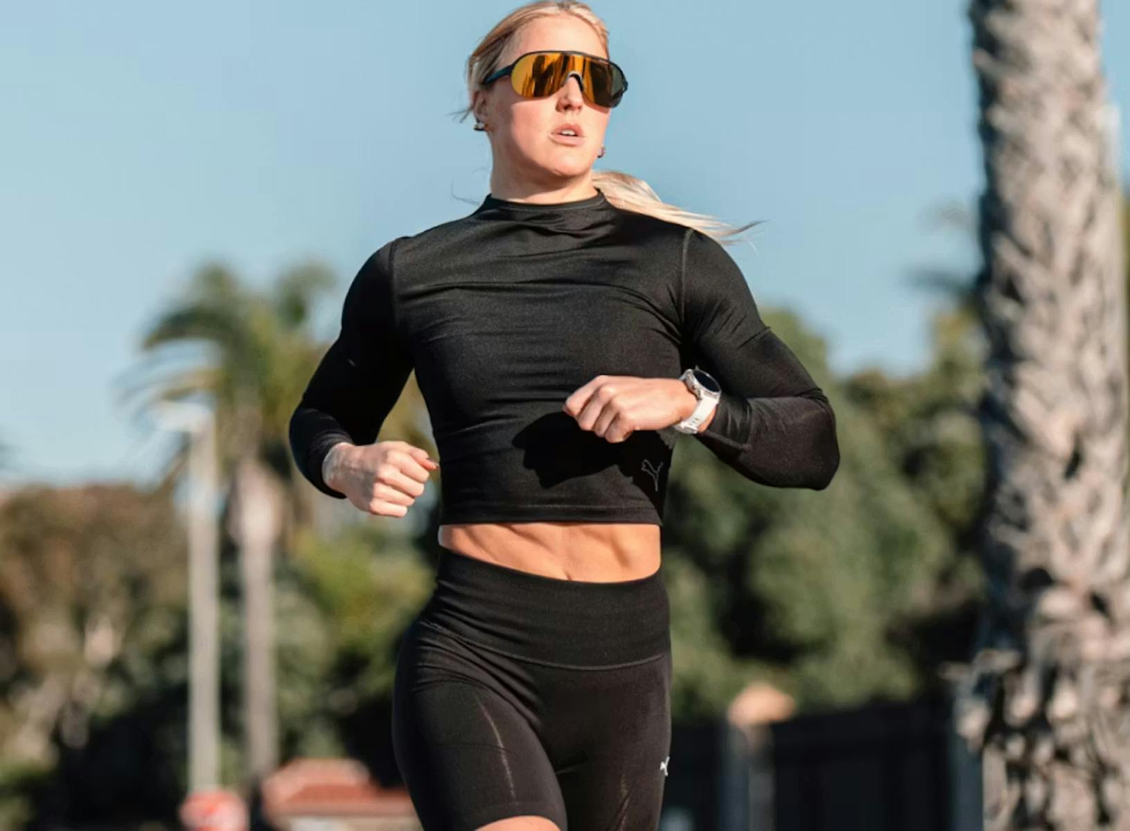 Woman running in black and gold sunglasses