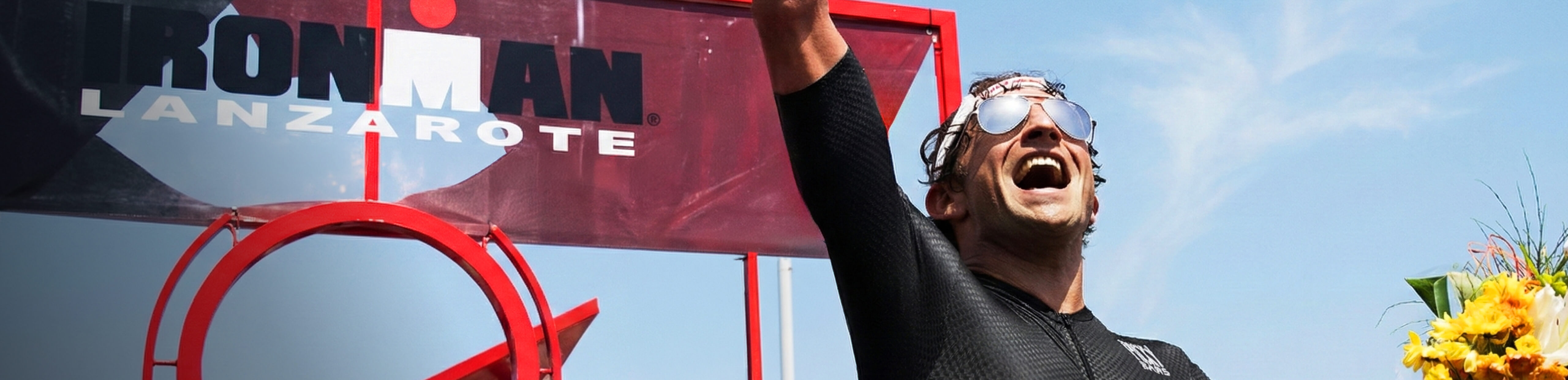 Man on ironman podium wearing ROKA aviators