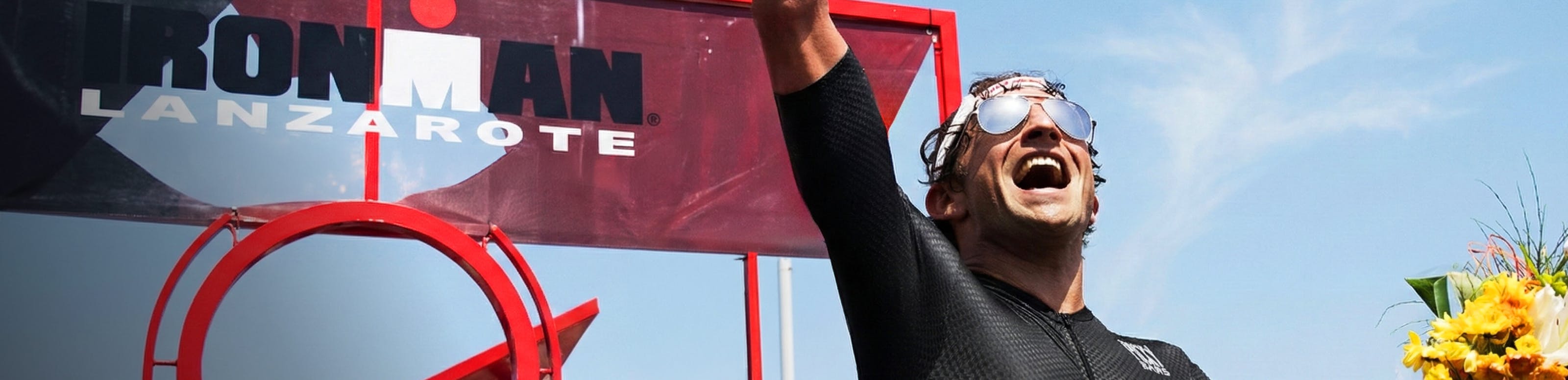 Man on ironman podium wearing ROKA aviators