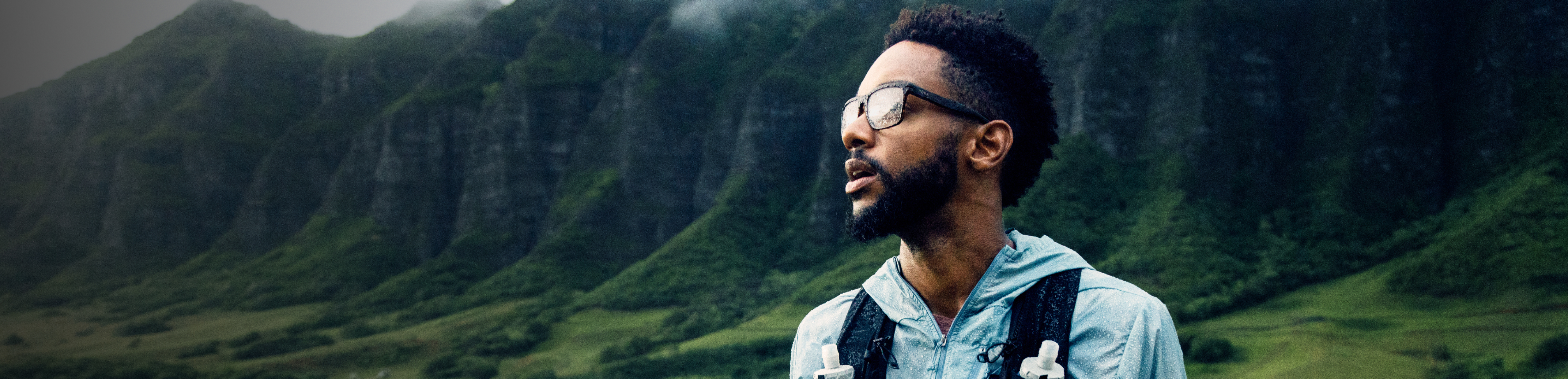 Man in woods wearing vest and ROKA eyeglasses