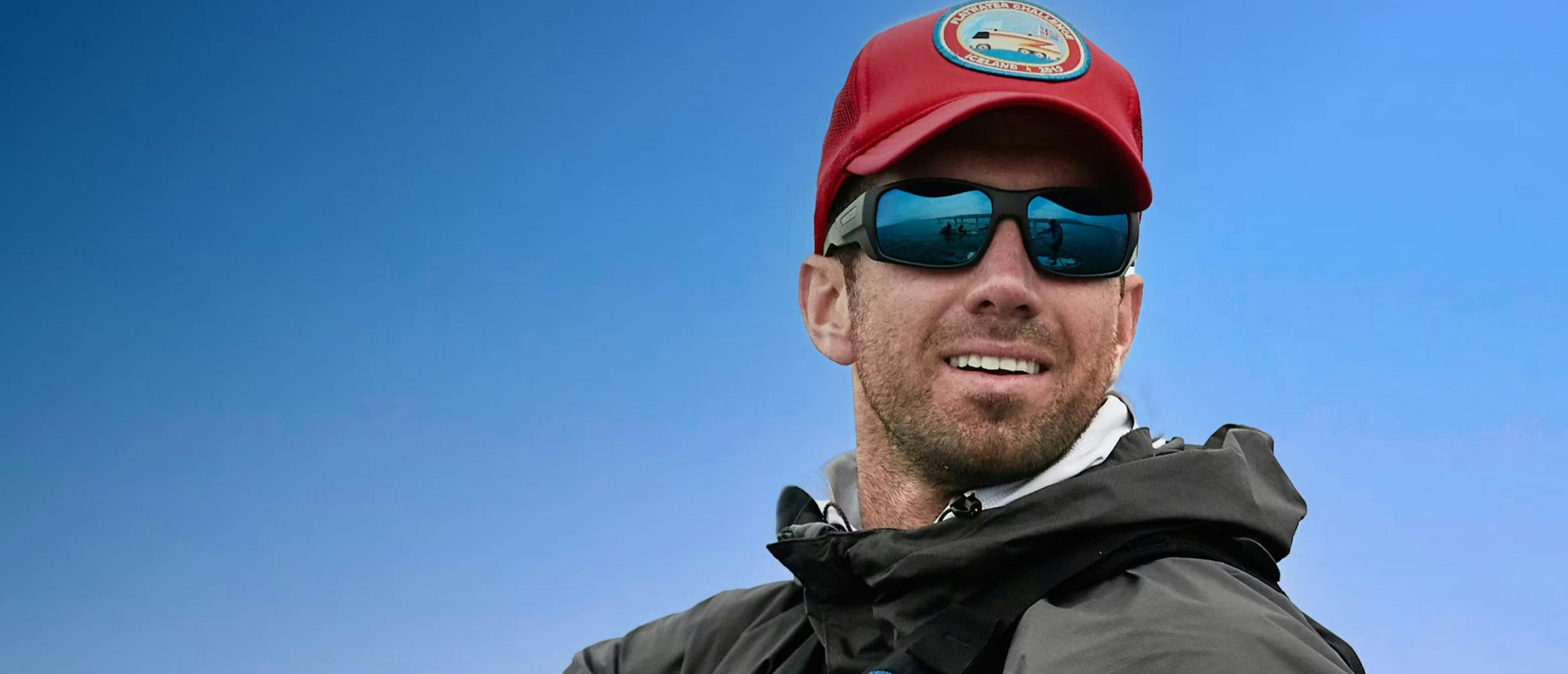 Man wearing red hat and ROKA blue mirror sunglasses