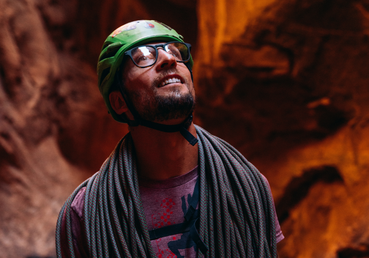 Man rock climbing wearing square, matte black Hunter eyeglasses