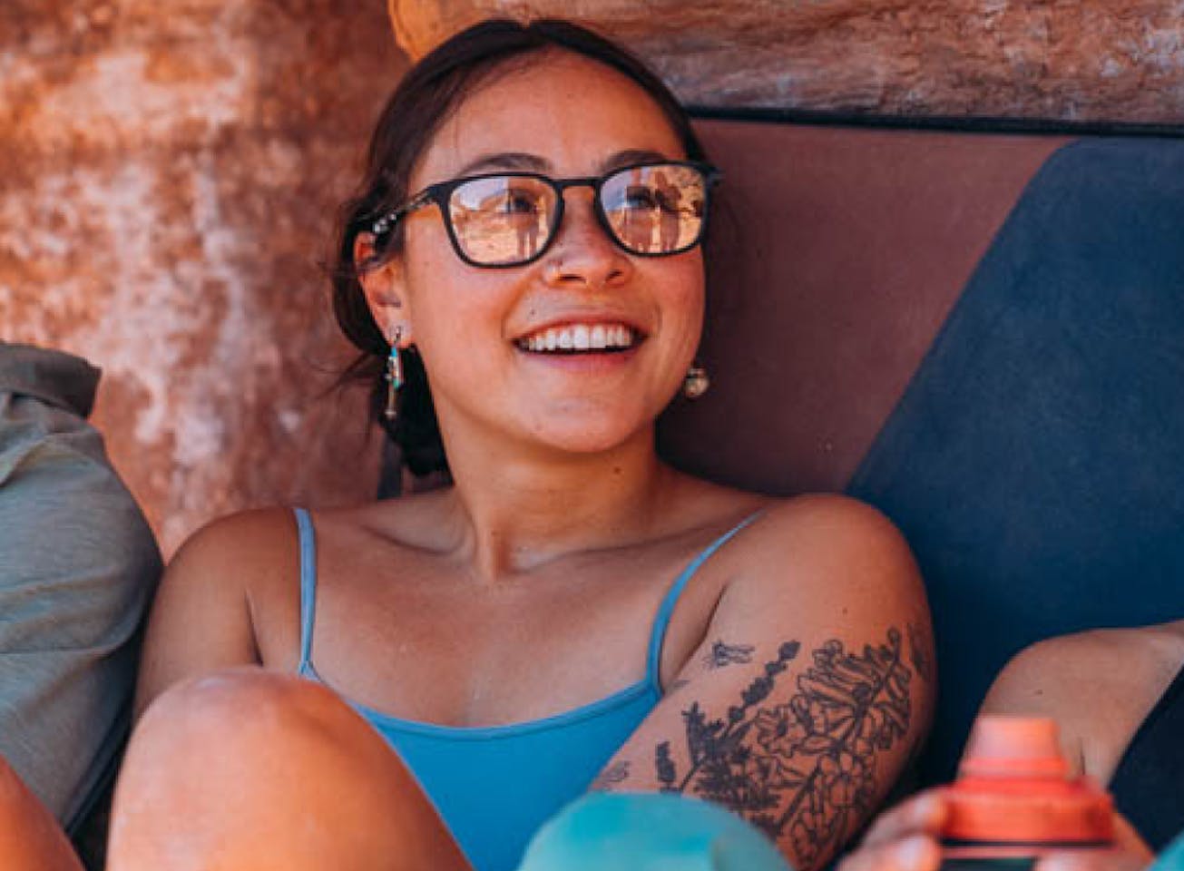 Woman with bouldering pad wearing Hunter eyeglasses