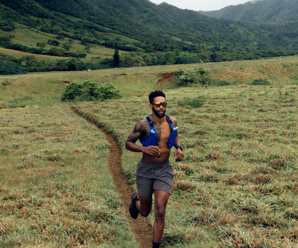 Man running on trail wearing Torino sunglasses
