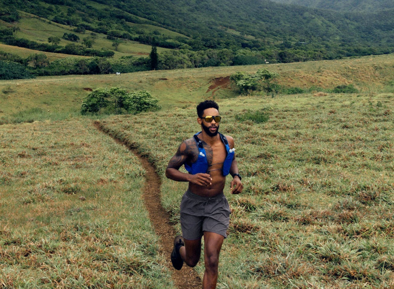 Man running on trail wearing Torino sunglasses