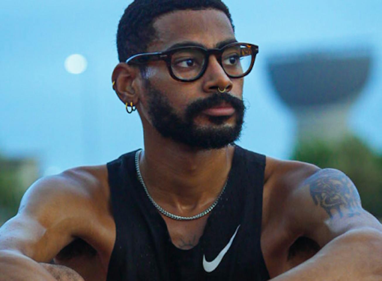 Man wearing black tank top and Hamilton eyeglasses