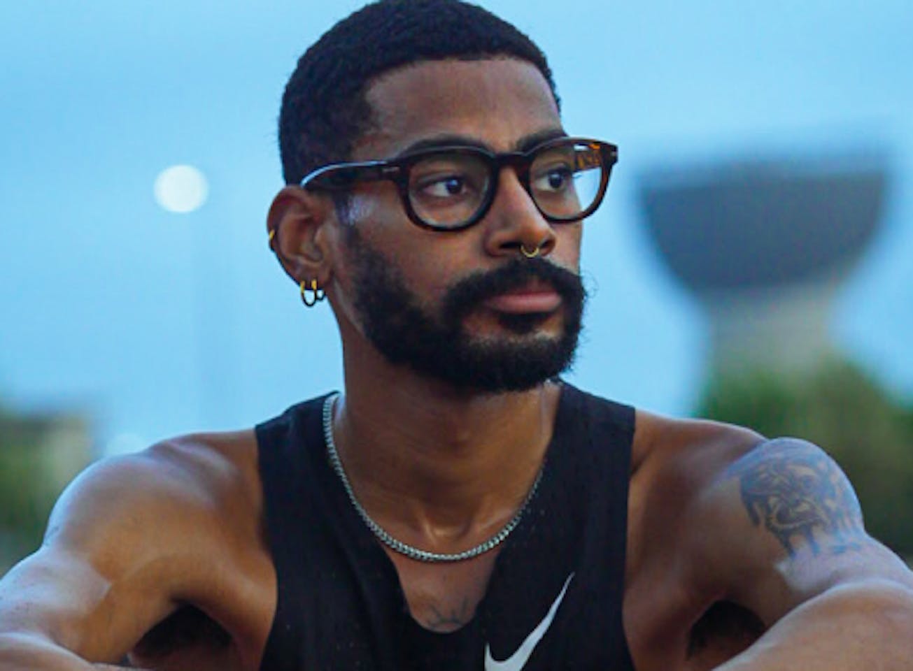 Man wearing black tank top and Hamilton eyeglasses
