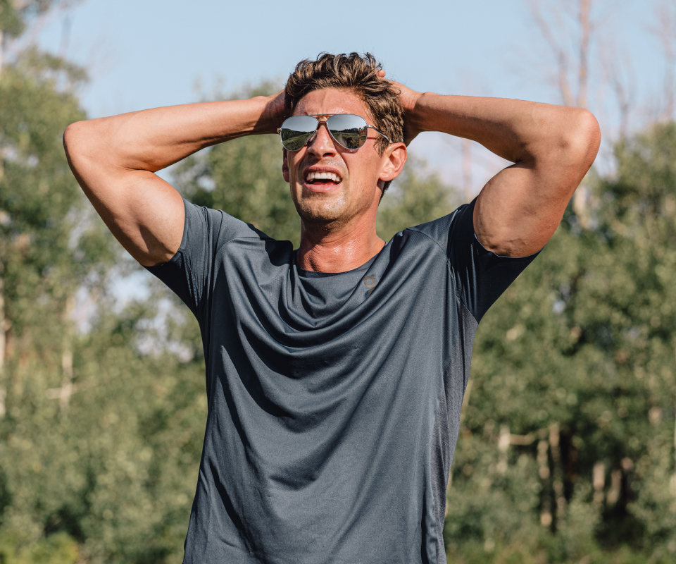 Man breathing with hands over head wearing Phantom sunglasses