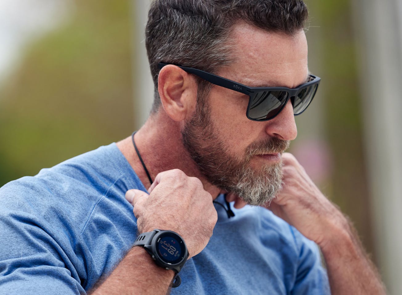 Man in blue shirt and Braker sunglasses