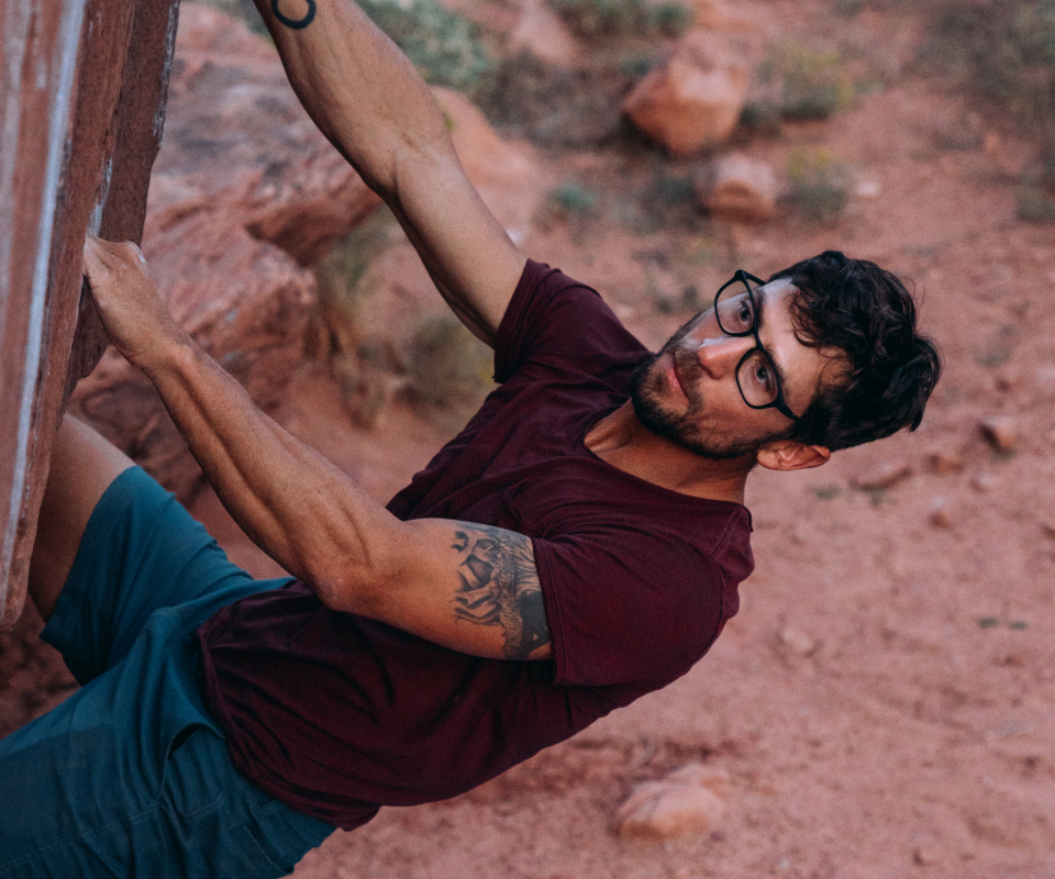 Man rock climbing in Cade eyeglasses