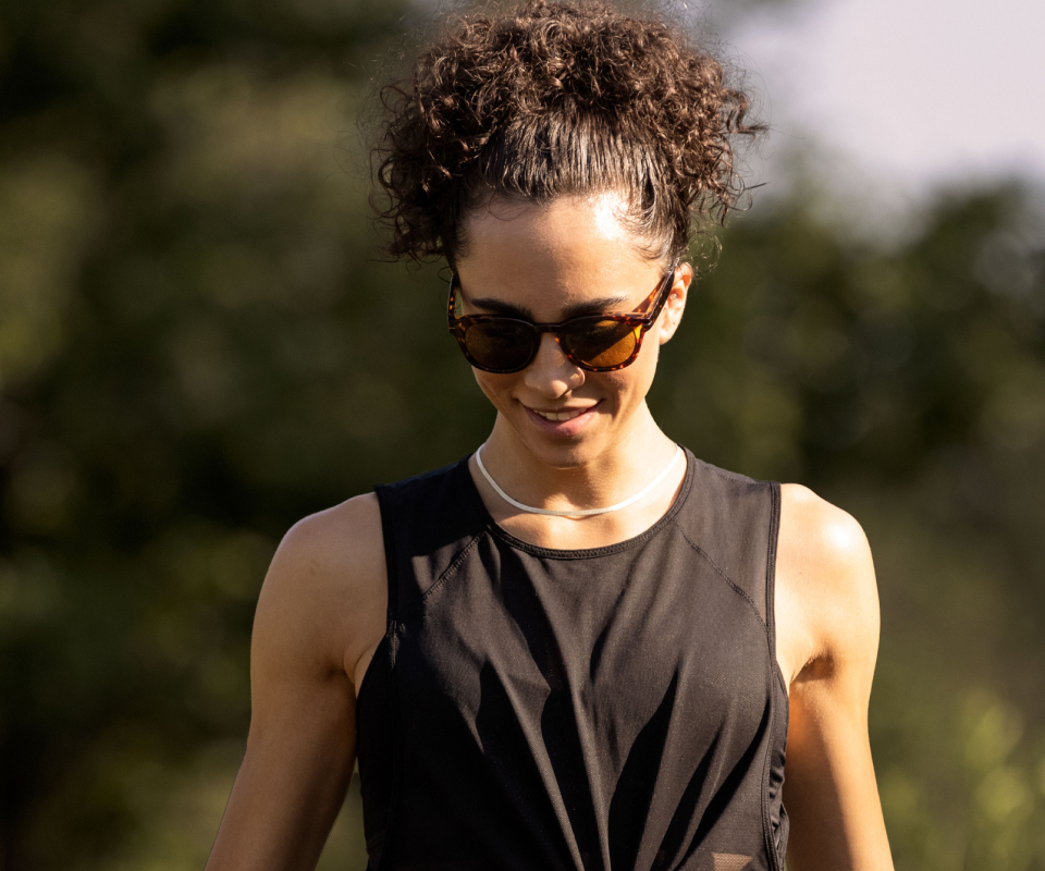 Woman wearing black tank top and Hamilton sunglasses
