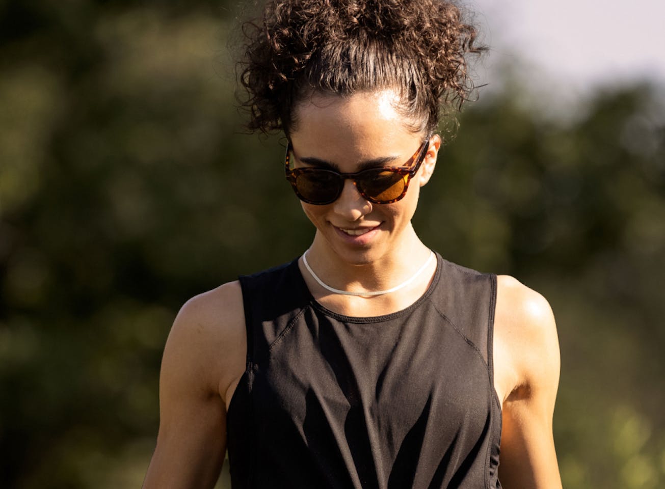 Woman wearing black tank top and Hamilton sunglasses