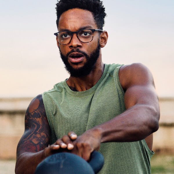  Man swinging kettlebell in ROKA eyeglasses